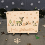 Geldgeschenk zu Weihnachten mit Tannenbäumen, Rentieren und Schneeflocken graviert