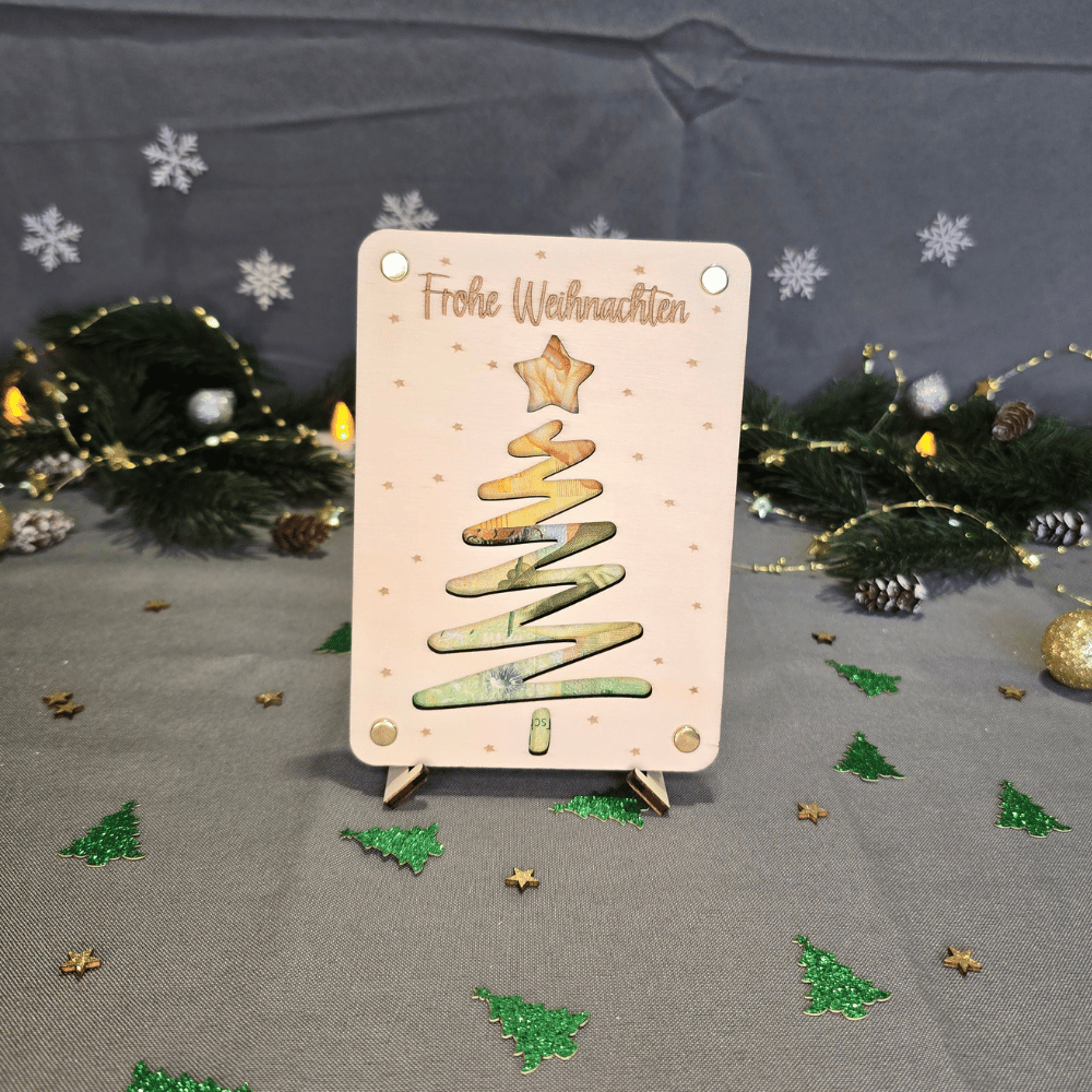 Kreative Geldgeschenk-Verpackung zu Weihnachten mit graviertem Weihnachtsbaum und Sternen